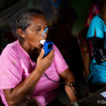 Older woman breathing from an inhaler