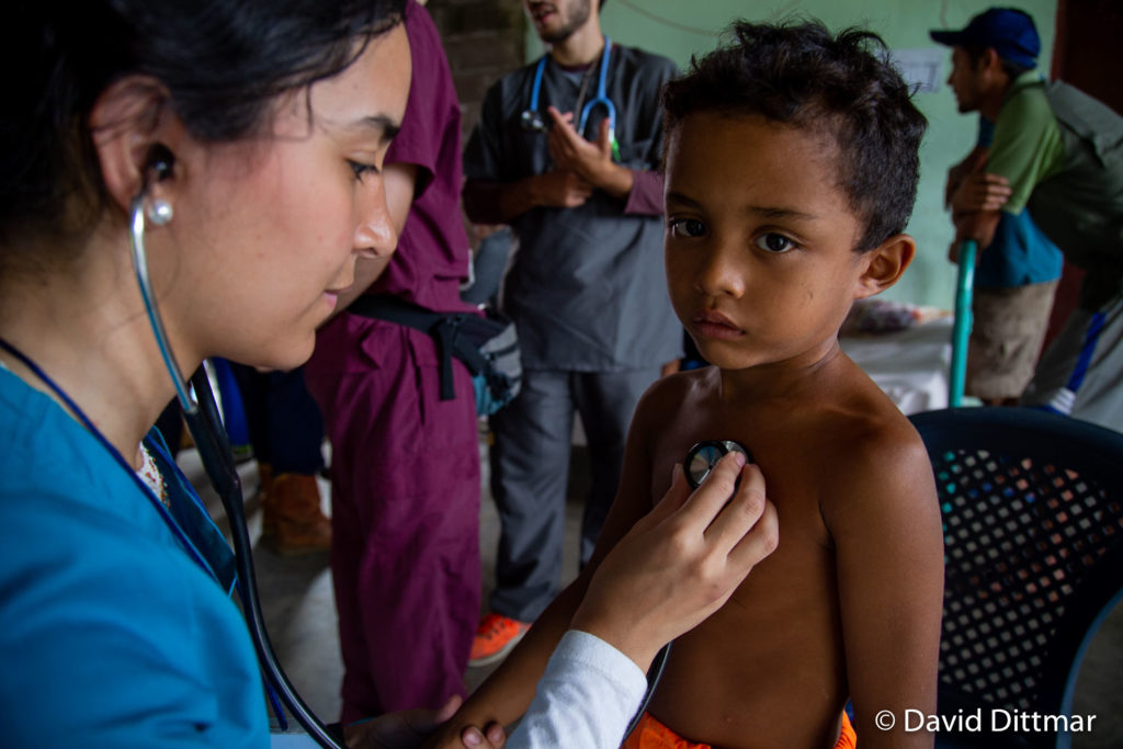 Doctor listening to child's heart rate