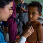 Doctor listening to child's heart rate